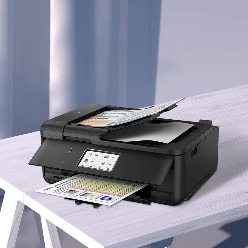 An inkjet all-in-one printer on a white table with printed photos